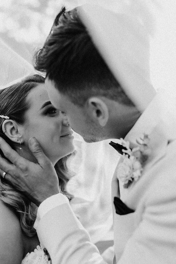 Bride and Groom kissing under veil captured by their Scenic Rim Wedding Photographer