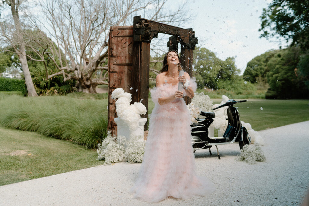 A bride pops a confetti canon during her Braeside Estate Wedding.